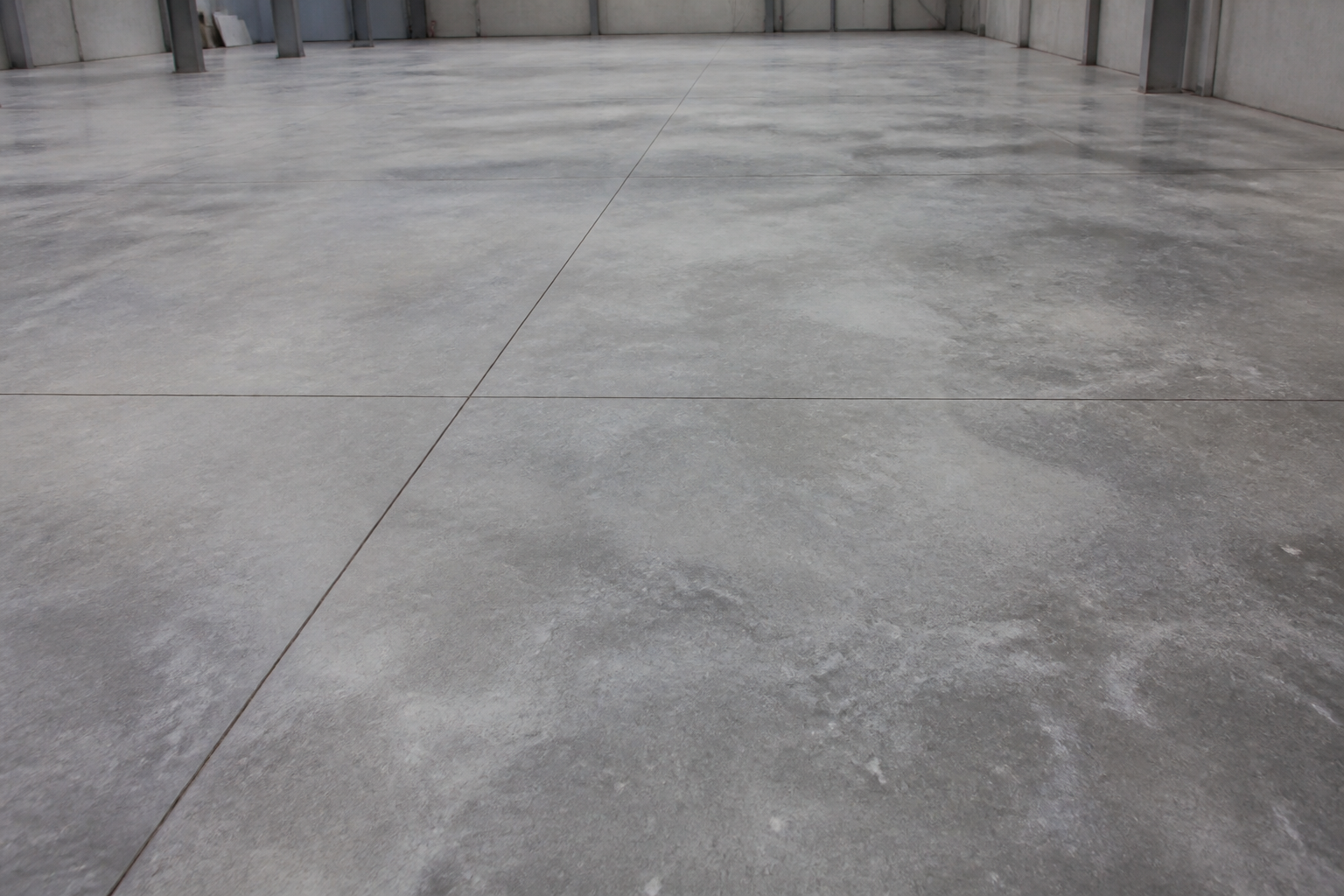 Luxury metallic marble epoxy flooring in a high-end interior showroom with deep glass reflection